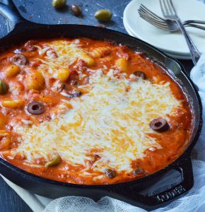Do you want an easy dinner with unique flavor? This Puttanesca Baked Gnocchi Recipe is a fun twist on a traditional pasta meal! Gnocchi are slathered in this briny red sauce filled with olives then topped with mozzarella and baked to perfection.